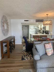 a living room and kitchen with a couch and a table at Ponce de Leon Towers in New Smyrna Beach
