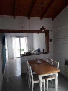 a kitchen with a table and chairs in a room at Los Choiques Madryn in Puerto Madryn