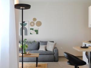 a living room with a blue couch and a table at Grey Rose in Kalabaka
