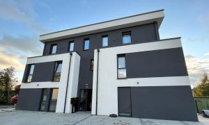 a black and white building with a sky at Elegantes Refugium in Düren in Düren - Eifel