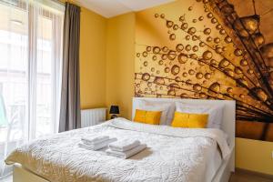 a bedroom with a bed with towels on it at Apartamenty Prestige Browar Lubicz Stare Miasto in Krakow