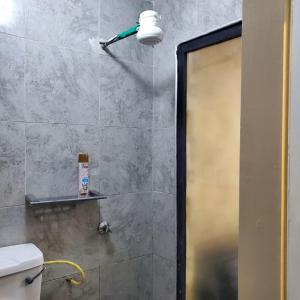 a bathroom with a shower with a shower head at Lovely & Cozy Compact Studio Near Airport with Rooftop View in Nairobi