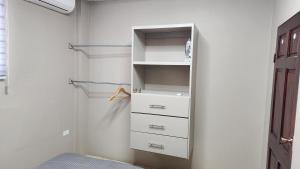 a white closet with drawers and a shelf at The Layover - 6 mins from the airport, Fully equipped for short and long stays in Kelly Village