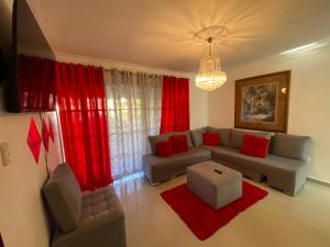 a living room with a couch and red curtains at Santo Domingo Paradise V - #211 in La Estrella