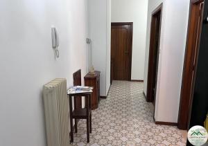 a hallway with a radiator and a table and a door at Montefortino Sibillini House in Montefortino