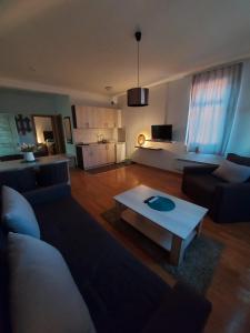 a living room with a couch and a coffee table at Apartmansko naselje DVORI in Kopaonik
