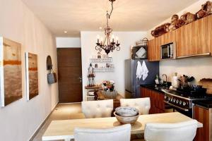a kitchen and dining room with a table and chairs at Casa Blanca By The Caribbean Sea in Akumal