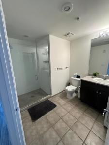 a bathroom with a shower and a toilet and a sink at lovely one bedroom in Orlando