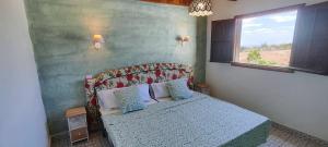 a bedroom with a bed and a window at Chalet Canario Panoramico in Maspalomas