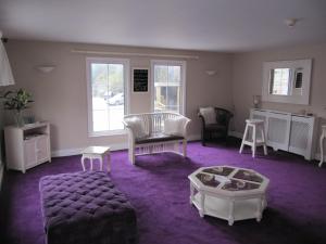 a living room with a couch and a table at The White Lady Hotel in Kinsale