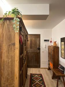 a hallway with a wooden door and a wooden table at Ski House Courmayeur in Courmayeur