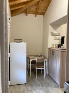 a kitchen with a white refrigerator and a table at Kalliopi Beach house in Kalliópi +31 photos