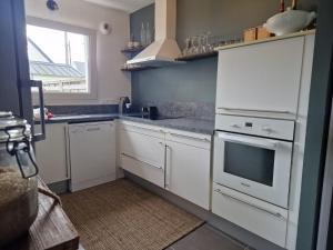 una cocina con electrodomésticos blancos y una ventana en La pause saline en Carnac