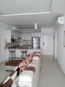een woonkamer met een bank en een keuken bij Grand Diamond Beach (TONSUPA) in Tonsupa