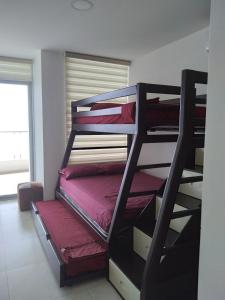 a room with two bunk beds in a room at Grand Diamond Beach (TONSUPA) in Tonsupa