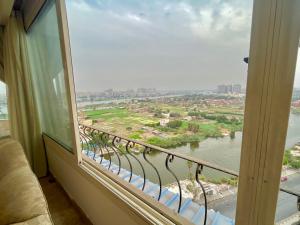 a window with a view of a river and a city at Luxury Villa By The Nile in Cairo