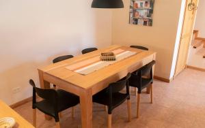 聖馬丁德洛斯安第斯的住宿－Casa en La Cascada，餐桌周围摆放着黑色椅子