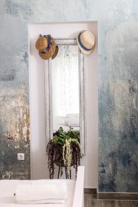 a mirror on a wall next to a table with a plant at Vila Lavanda in Bribir