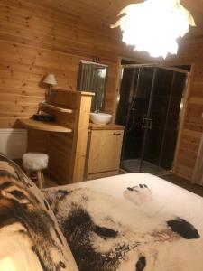 a bedroom with a bed and a bathroom with a shower at Chalet Cervus in Font-Romeu-Odeillo-Via