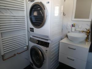 a washing machine in a bathroom next to a sink at Pohorsko-chata in Pohorsko