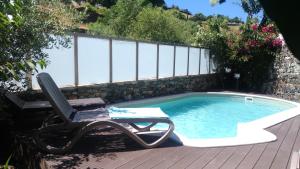 a chair sitting next to a swimming pool at Casa do Rio Fervença in Bragança