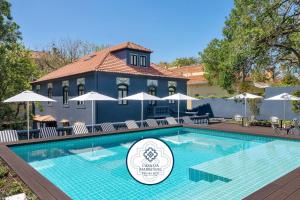 a swimming pool in front of a building at Casa da Marechal - Boutique Hotel by Oporto Collection - Adults Only in Porto