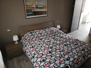 a bedroom with a bed with a black and red blanket at B&B Antico Porto Tarquinia in Tarquinia