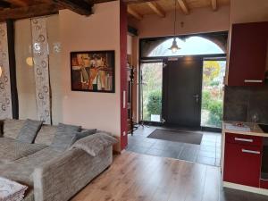 a living room with a couch and an open door at Das Castellchen in Castell