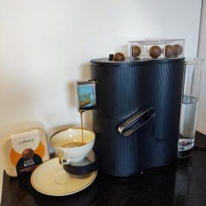 a coffee maker sitting on a counter with a bowl of coffee at THE BEST LAKE HOUSE -3 minutes to the train in Spiez