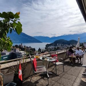 a balcony with a view of the water and mountains at THE BEST LAKE HOUSE -3 minutes to the train in Spiez