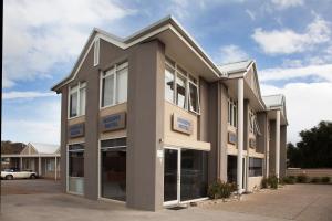 a large office building with a parking lot at Moody's Beach Apartment in Blairgowrie