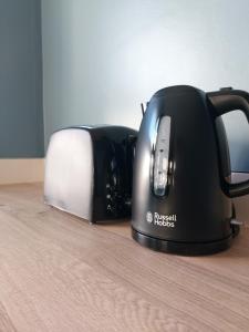 a toaster sitting on top of a wooden table at Cathedral Quarter Apartments in Derry Londonderry