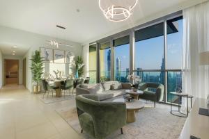 a living room with a couch and chairs and a table at 3+1 BR, Burj Khalif, Dubai Mall in Dubai