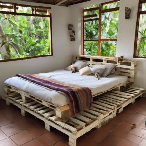 a bed made out of pallets in a bedroom at EcoHostal Nature EcoFit 06 in Playa Punta Arena