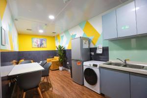 a kitchen with a refrigerator and a sink and a table at B101 Boutique City Loft in Coventry
