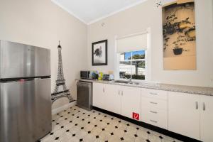 a kitchen with a refrigerator and the eiffel tower at Kits Coty in Katoomba