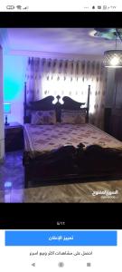 a bedroom with a large bed with a large headboard at شقة مفروشة مكيفة للايجار بجبل طارق 