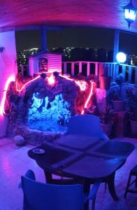 a living room with a stone fireplace at night at شقة مفروشة مكيفة للايجار بجبل طارق 
