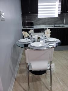 a table with two plates and glasses on it in a kitchen at Luxurious 1BR-1BA Apartment Bright Spacious with free parking-gc-1 in Brampton