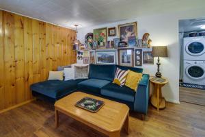 a living room with a blue couch and a table at Newport Cabin on Diamond Lake with Private Boat Dock in Newport