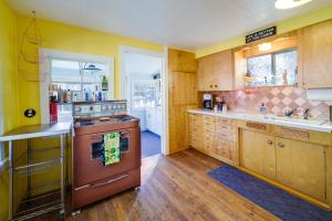 a kitchen with wooden cabinets and a stove at Newport Cabin on Diamond Lake with Private Boat Dock in Newport