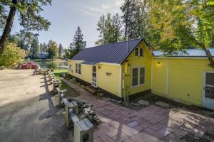 a yellow building with a solar roof and benches at Newport Cabin on Diamond Lake with Private Boat Dock in Newport