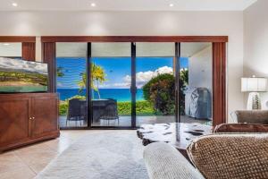 a living room with a view of the ocean at MAKENA SURF, #C-103 condo in Wailea