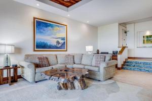 a living room with a couch and a coffee table at MAKENA SURF, #C-103 condo in Wailea