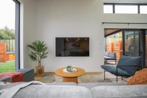 a living room with a couch and a table at The Sanctuary in Rotorua