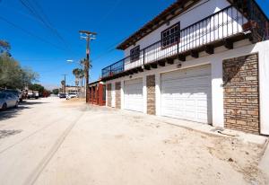 a building with two garage doors on a street at Casa Barquito - Pool house in San Felipe in San Felipe