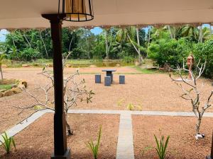 a park with a picnic table and a pole at COCO RELAX AYURVEDA VILLAS in Hikkaduwa