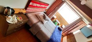 an overhead view of a couch in a room with a window at Casa Mirador guesthouse in Cusco