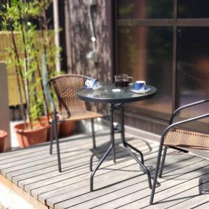 una mesa y sillas en un porche con una mesa y tazas en 竹の宿, 