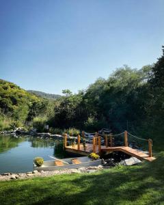 a bridge over a river with a boat on it at Forrest Relax & Spa in Rakovac